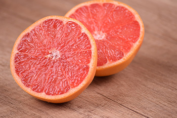 Grapefruit originated due to an accidental cross-breed of a sweet orange and pomelo. It’s a member of the Rutaceae family, growing on trees in tropical regions. The name grapefruit comes from how the fruit grows in clusters on a tree, similar to grapes.