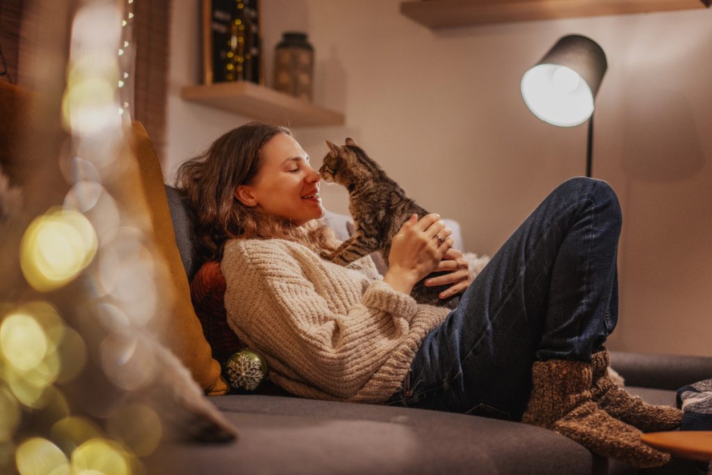 woman inside with a cat